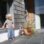 a young visitor admires the entrance to the Chalk Wall House